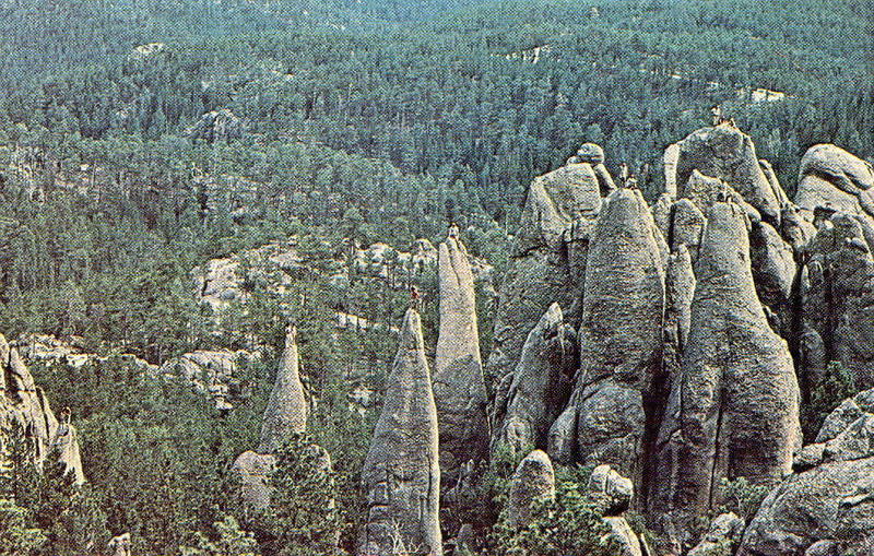 This is a photo that Paul Muehl had taken and produced into a postcard for his climbing friends. For several years in the late 1970's to the early 1980's we had a group of friends always show up for the second week of August and we all climbed and climbed and climbed. One day we would all go to the Ten Pins and do them all. This is a photo of someone on every summit. This Climb-a-thon was August 1979