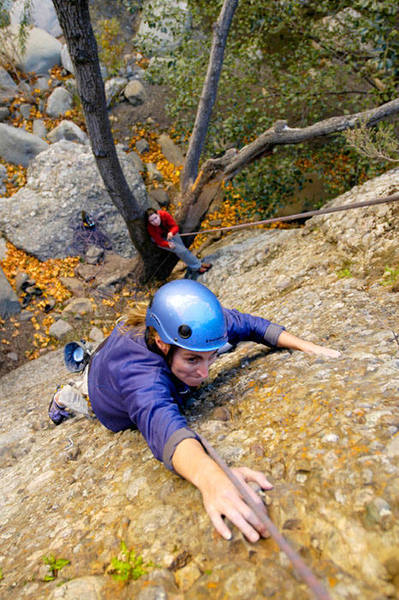 It's like climbing up the chimney of a little cottage in the woods--a real fairy-tale of a route.  Here, Marisa Fienup, of Ventura, makes the long reach between positive holds.