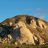 Saddle Rocks from the road near Hall of Horrors. The Theoretical Boulder is visible to the left and the Cowboy Crags up and to the right.