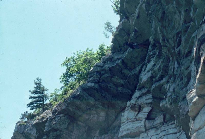 1976 pulling the crux roof. Exit Stage Left and Gem's Gym cut through the roofs further left. Psychedelic (5.8 and wild) climbs near the right edge of the photo.