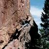 Greg Hand (in a previous century) beginning the crux during the redpoint.