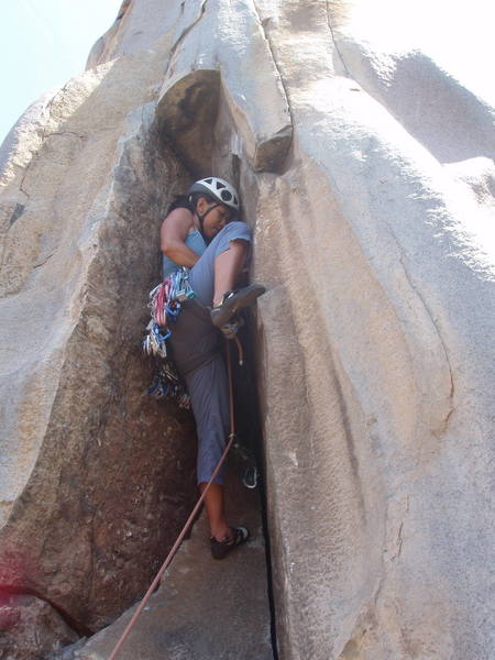 Angelina Kalianda searching for a placement before she commits to crux moves.