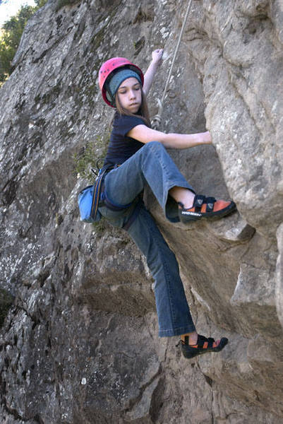 On just her third trip climbing outdoors, thirteen year-old Maria, of Chicago Illinois, cranks through the crux roof of "Chummin" (5.11b).