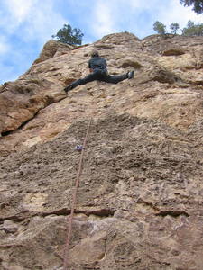 Peter Dillon at the crux bulge.  Traverse right to keep the route at 5.9; go straight up the bulge to make it 5.10a or b.