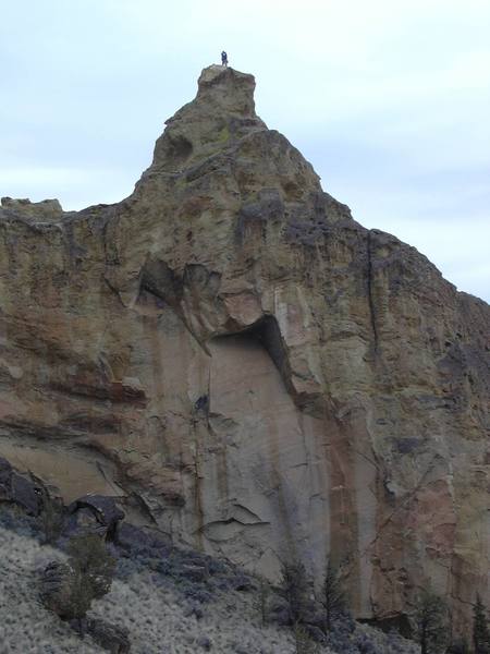 Climber on the summit of Brogan Spire above the Great Roof.