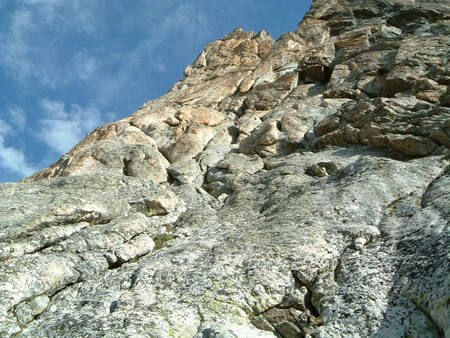 Start of the climb, located near a big tree on a ledge.<br>
<br>
If traversing in from the Caves, you will be about 40' higher. I would offer to make an intermediate belay to keep the rope free from a flake constriction before getting to the start of P2.