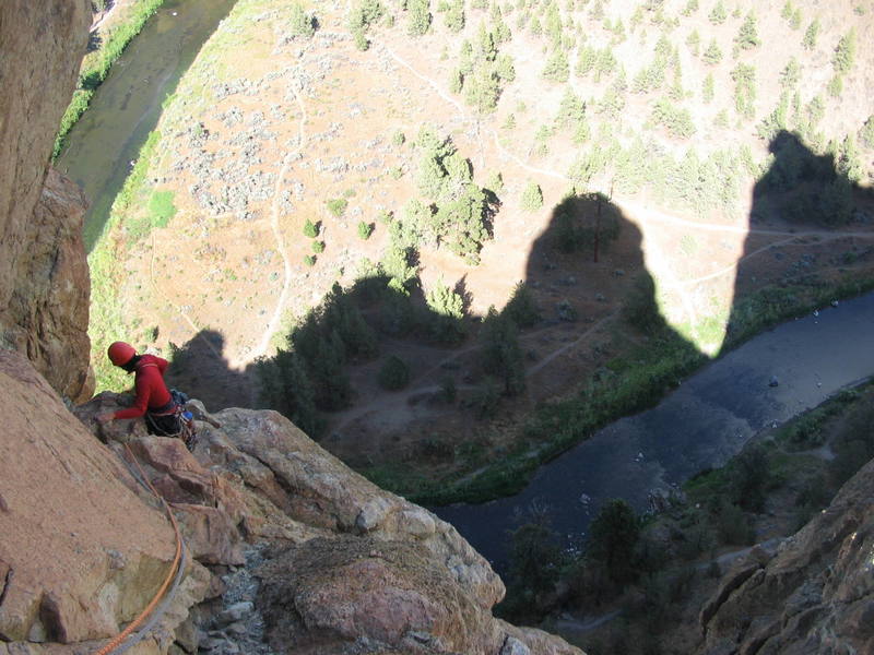 Topping out on Snibble Tower's 4-star 5.9 pitch.  300 feet of 4th class choss remain to the walk off.  Shadows of Snibble Tower (left) and Smith Rock Summits (right) visible below.