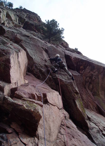 Approaching the P1 crux. The flake my left hand is on is suspect. You can get one good big brass nut just above this flake in the main corner. The gear below is dependent on the flake holding. If you're tall, the crux is getting stood up where my hand is. If you can't reach the jug from there, the next move may be the crux. I Did it My Way is just to the right.