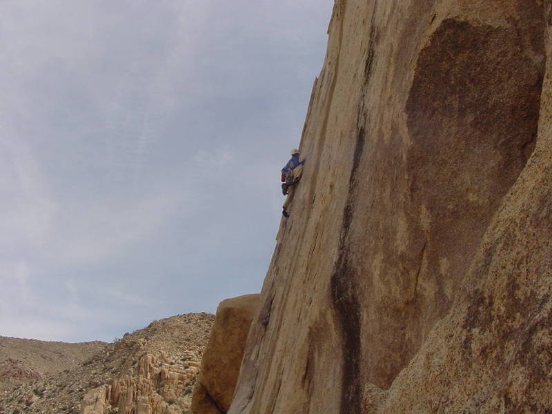 Tom Murphy edging his way to the crux on the initial 5.10 portion of the signature 2nd pitch on Spirited Away.