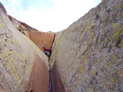 Looking for nonexistent footholds at the start of the 5th pitch.