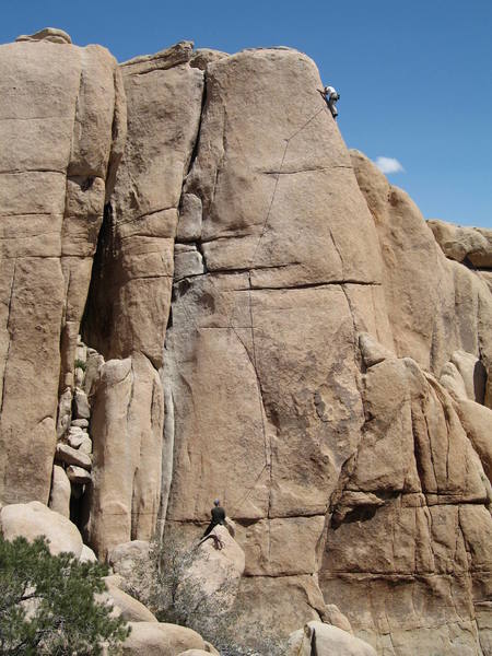 Nice shot of the whole climb.  Start off the block where the belayer is sitting.  Some gear (including some fiddly gear) gets you to the well protected bolted face climbing.