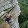 Gaining the point.  The crux sloper is the faintly orange-colored angled thing in the upper left corner of the photo.