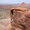 Michael Trostrud pulling the crux 5.6d move with North Sixshooter in the background.