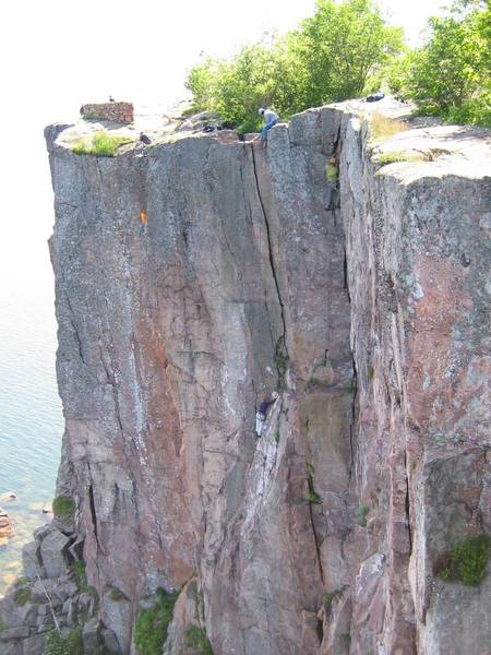 Climber in yellow on Hidden Treasure, climber in purple on Phatom Crack, and climber in green on Bluebells