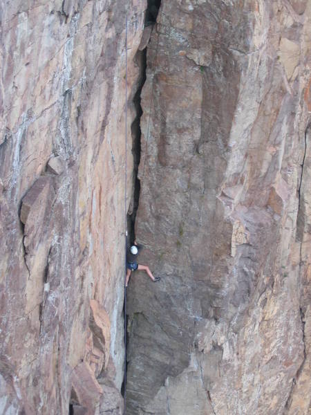 An unknown climber stemming up Superior Crack.