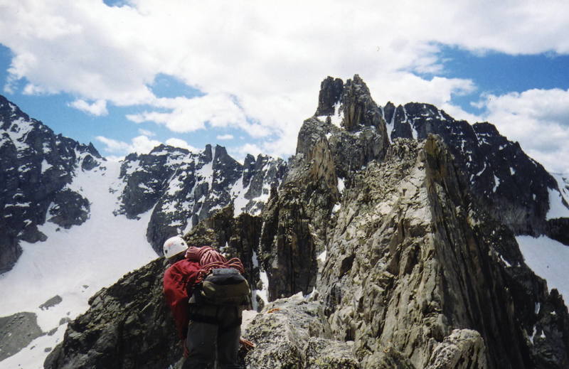 Diamond Dave traversing off the summit of Lone Eagle. In the background is Iroquois Peak and Fair Glacier on the left.