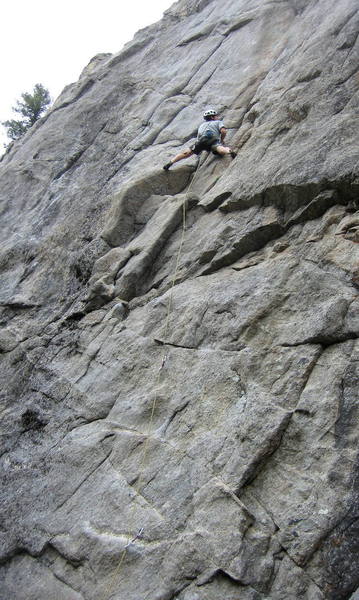 Climber at the two-bolt anchor atop the first pitch of Leviathon.  He is doing the climb as one pitch, and is facing the steep crux section just above the anchor.