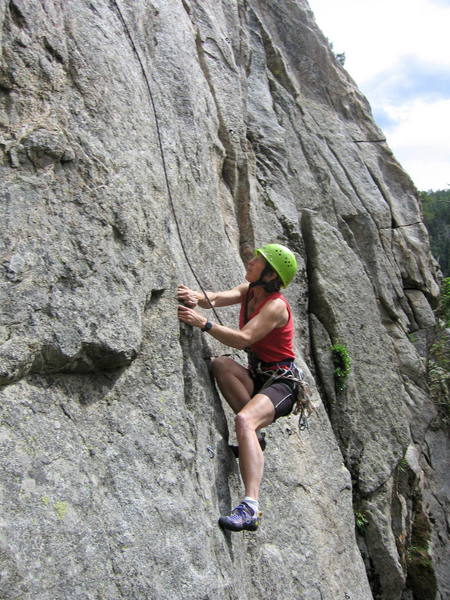 Jean Aschenbrenner at the hard moves just above the first bolt on Dry Ice.