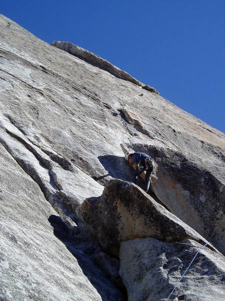 One more move to get the jug top and onto Log Ledge.  The second pitch can be seen above with a crux being a couple of crimp moves off the ledge, then up and right the large chicken head.  Up past 3 bolts and then a delicate traverse right to the bottom of the left facing corner.  You step right on the face just right of the corner and continue up a long way with no pro to the achors.