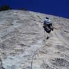 Paul contemplating which way to go. The Sundance finish goes up past the black streak and into a tiny crack system which looked tricky to protect and quite run out.  The left dike system (Sundike) looked much more interesting and fun.