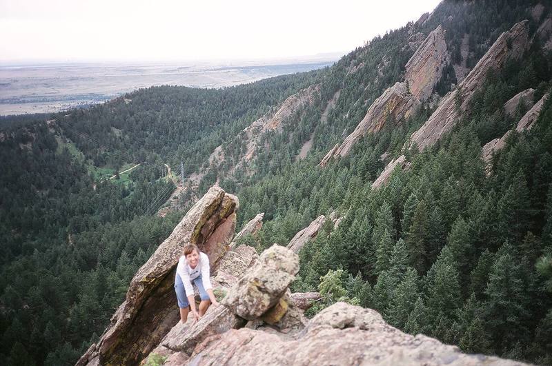 Patty J. Soloing on the Front Porch (Flatirons of Boulder) with Der Zerkle, Dinosaur Rock, & Overhang Rock in the background.