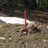 June 2006 - this little sign off the service road marks the approach trail down to the buttress.  We left our packs here (hang them!)