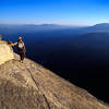 Matt Grieger takes in the view from 11 pitches off the deck as smoke from a rapidly building fire casts an eary glow.  The Magician Needle.<br>
www.EarthworksImagery.com