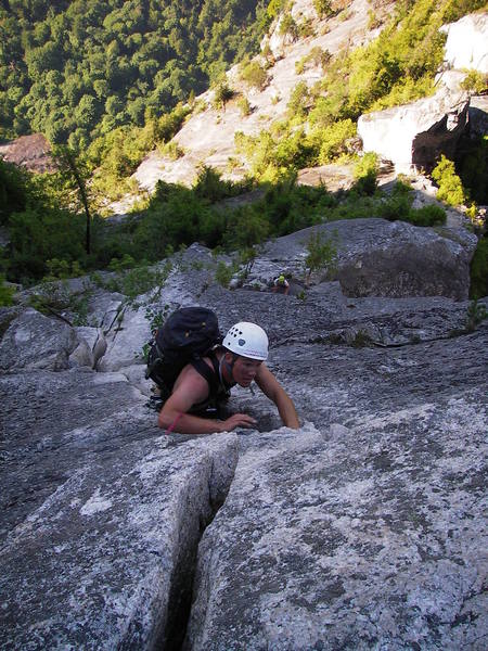 Climbing up the last 5.10a pitch.  The Acrophobe's Traverse can be seen in the top right.