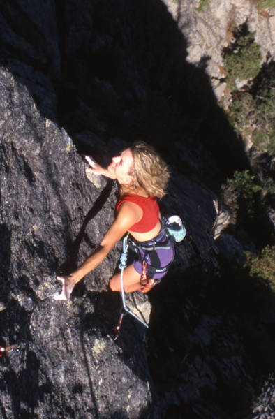 Melissa Meyers having just cleared the crux considers the steep arete above.  Photo: R. Rossiter.