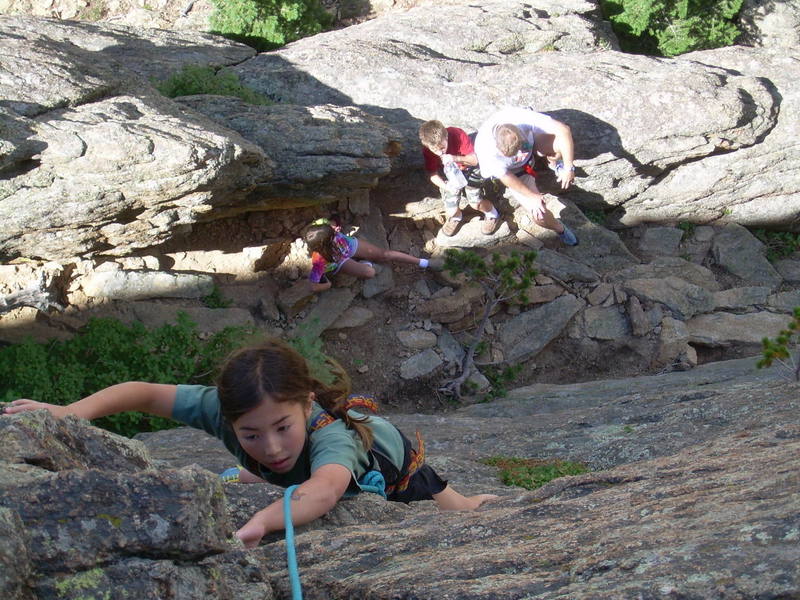 Kira, 10, face climbing the crack.