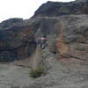 Tony getting started into the leaning handcrack of Marlin Alley (5.11b) on Batman Rock at Lumpy Ridge, CO. Image by Todd Miller.