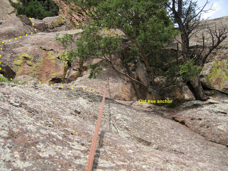 The new bolted rappel anchor at the top of the Upper Ramp. Installed 8/21/06.<br>
<br>
Traverse in from climber's left to avoid using the tree to downclimb.<br>
<br>
The rope pull is clean with little friction.  The rope only contacts the rock at the edge of the dropoff (where this photo was taken).<br>
<br>
The old tree anchor is just to the right.