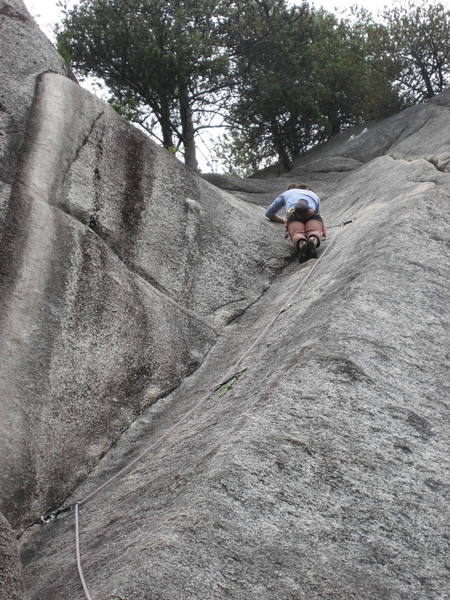 Shannon contemplating the slabby crux on Popeye and the Raven.