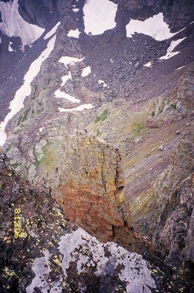 Climbers summiting the Petit Grepon, as seen from the Sabre in failing weather. Photo by T. Bubb 8/06.