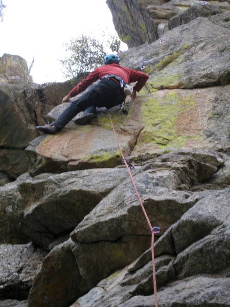 Ron Olsen stepping up to a great horizontal edge at the start of the arete.<br>
<br>
Photo by Bruce Hildenbrand.