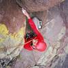 Ross Coming up under the sandbagged roof on Stretch (5.9+) at Trojan Bunny Buttress in Colorado's SSV. Photo by T. Bubb, 9/06.