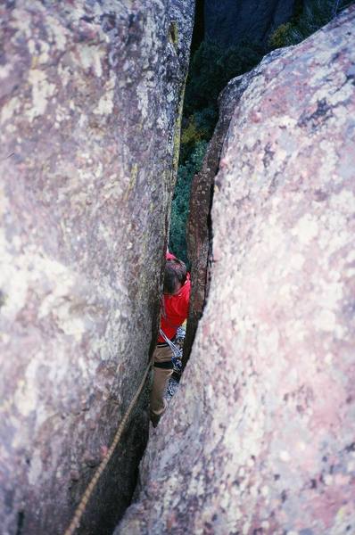 Chris Parks sizes up the crack in the overhang above him on "Euclid's Corner" (5.10c, PG-13) on Ridge 3 of Skunk Canyon in the Flatirons.