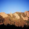 From left to right... The Tower of The Moon (small, shaded), the Jamcrack Spire, the Maiden, the Fatiron, The Devil's Thumb, the Flying Flatiron, and the Devil's Wings as viewed from the South-East on the Old Mesa Trail.