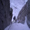 Rappeling the second pitch of the left chimney variation during heavy spindrift.