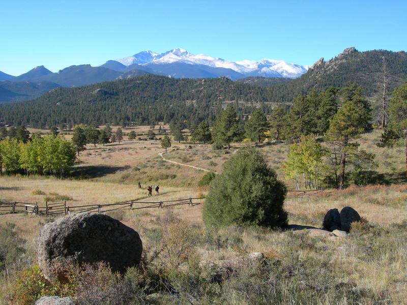 A couple of climbers head toward the Book on a beautiful late September day, framed by the backdrop of Longs and Meeker cloaked in a dusting of new snow.