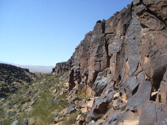 looking down the sunny side of black rocks