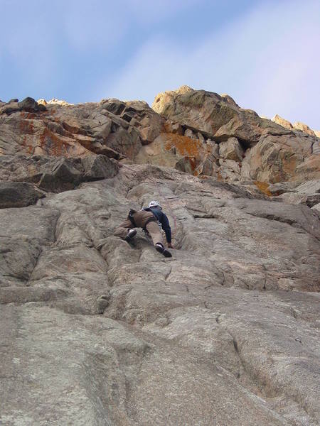 Move into the shallow left facing corner before stepping right onto the steep crux face.<br>
<br>
Photo by Paul Rezucha.