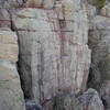 Part of the rampart. The Good, the bad, and the Jacked climbs the black streak behind skinny tree on the left.  The second part of Cracker Jack can be seen in the middle.  And Wild West Homo is the face on the Far right.  This is looking at it from the top of Son of Great Chimney. 