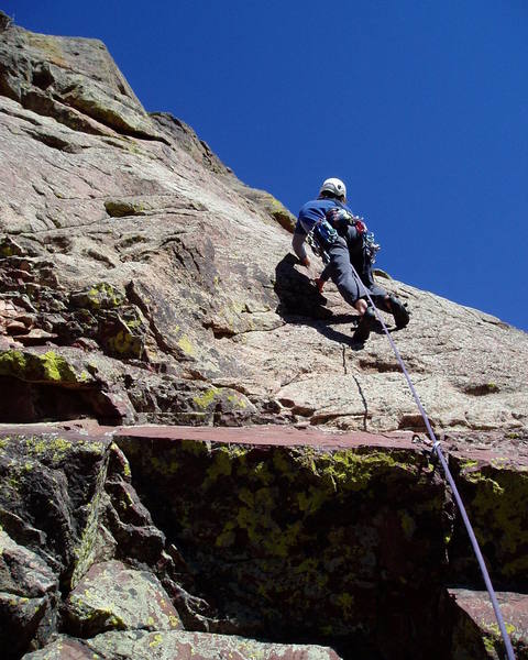 Climbing the fun slab above the annoying starting roof on P2. Greg is skipping gear here, and ended up not placing any gear on this pitch.