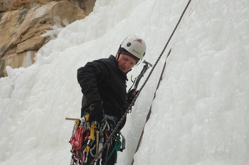 Me getting ready to place a ice screw on the first pitch.