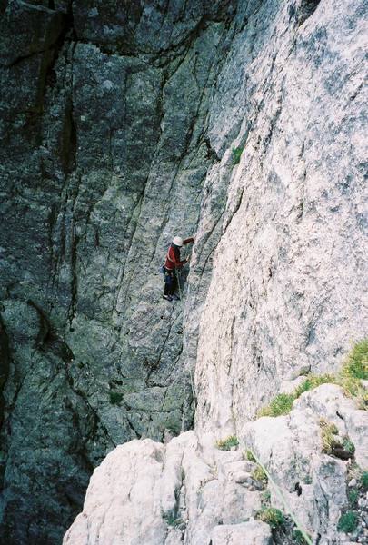 Bill Weiss topping out in the large dihedral on the bottom half of the route.  We stepped right onto the big terrace, then did an angling traverse up and left to gain access to the large arching corner which defines the route.