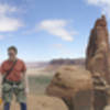 Ian on top of Thumbelina with the tops of the other 5 Bridger Jack spires in the background.