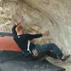 Andy bouldering in the chaos cave, Red Monster Area, Ibex