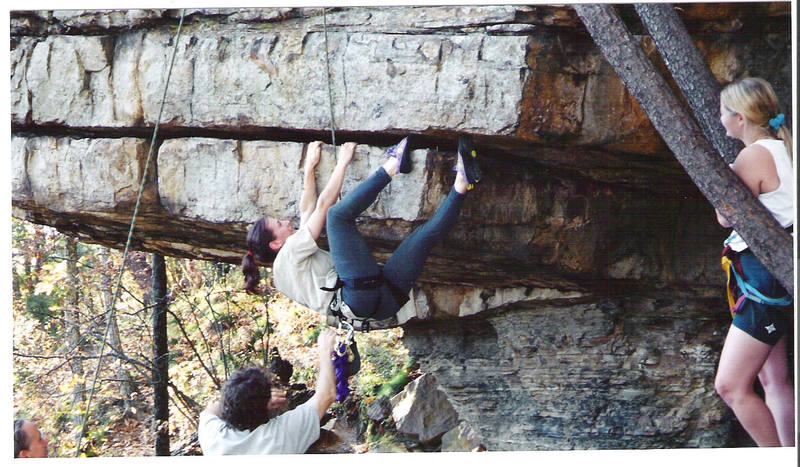 The climb starts on the far right of the roof.  Hand traverse left, throw a heel hook in, and shoot for the jug.