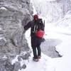 Hugging the wall on the way to climb the Ripple in Eklutna Canyon